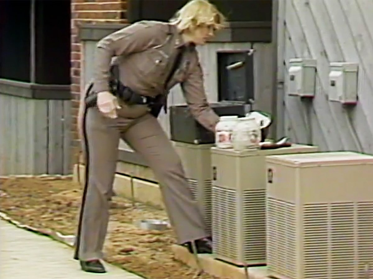 Photo of policewoman working the McAdams' crime scene.